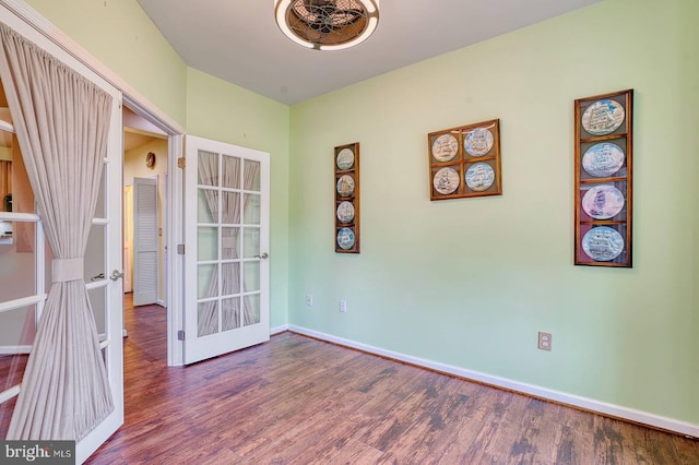 empty room with hardwood / wood-style floors and french doors