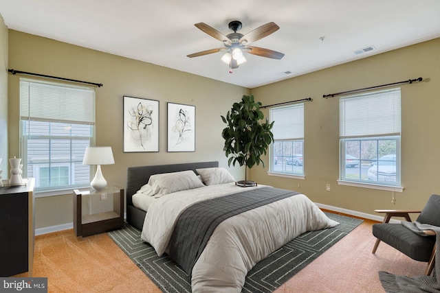 bedroom with light colored carpet and ceiling fan