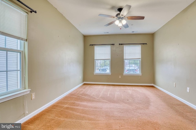 carpeted spare room with ceiling fan