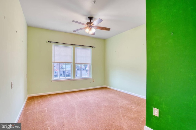 empty room with carpet flooring and ceiling fan