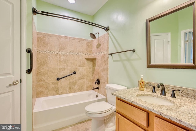 full bathroom featuring tile patterned flooring, vanity, toilet, and tiled shower / bath