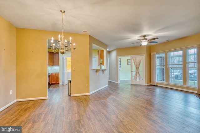 interior space with dark hardwood / wood-style floors and ceiling fan with notable chandelier