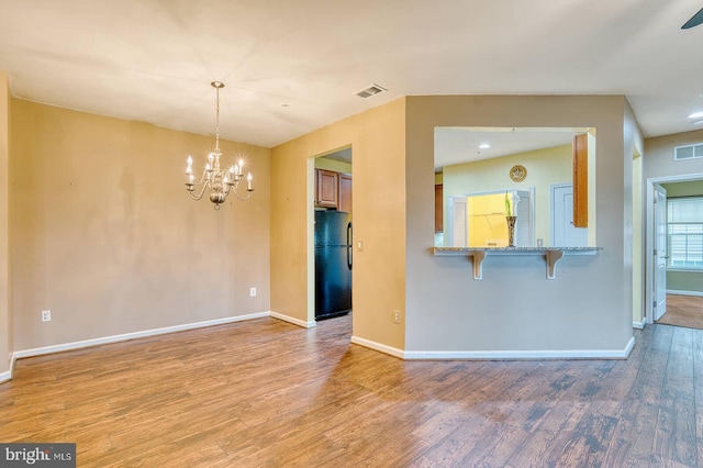 interior space featuring light hardwood / wood-style flooring and a notable chandelier