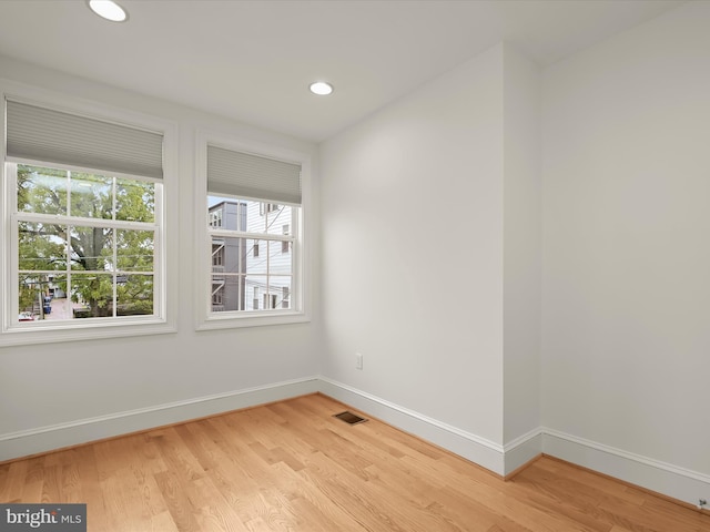 spare room with light hardwood / wood-style floors