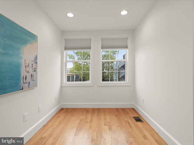 spare room featuring light wood-type flooring