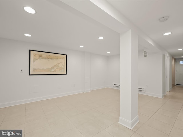 interior space featuring light tile patterned floors and a baseboard heating unit