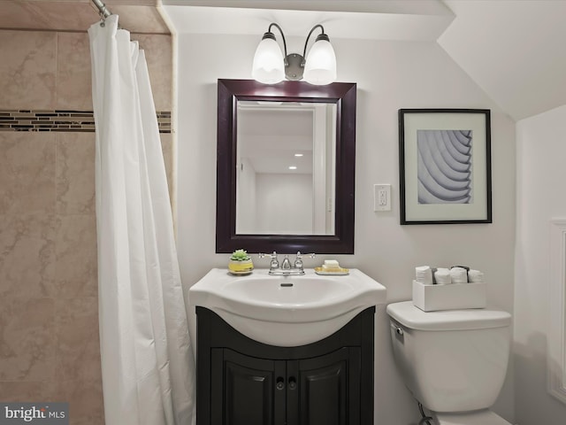 bathroom with curtained shower, vanity, lofted ceiling, and toilet