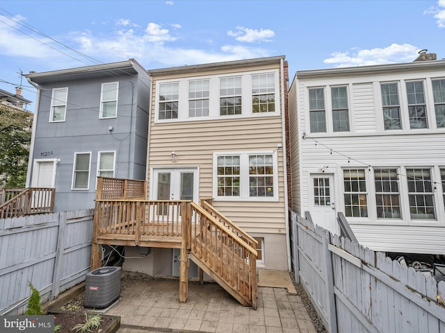 rear view of house featuring central AC unit