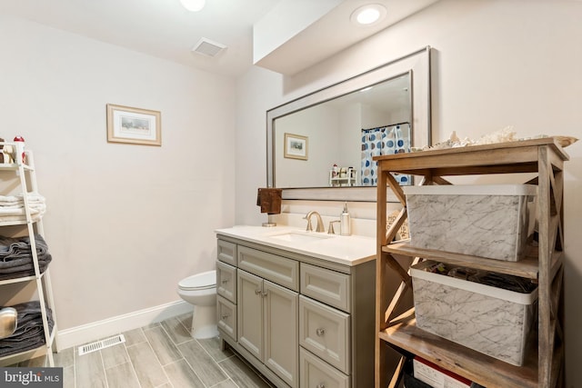 bathroom featuring toilet and vanity