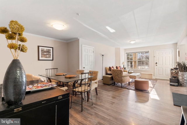 dining space featuring hardwood / wood-style floors and crown molding