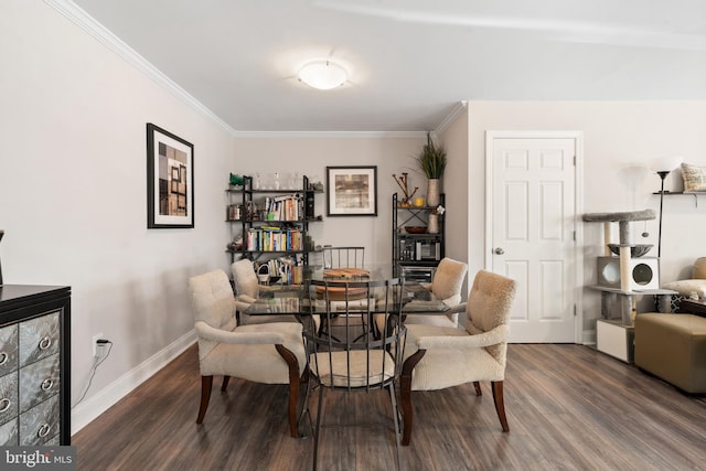 dining area with ornamental molding and dark hardwood / wood-style flooring