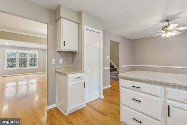 kitchen featuring white cabinetry, ceiling fan, and light hardwood / wood-style flooring