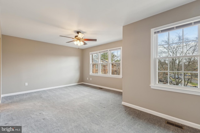 carpeted empty room featuring ceiling fan