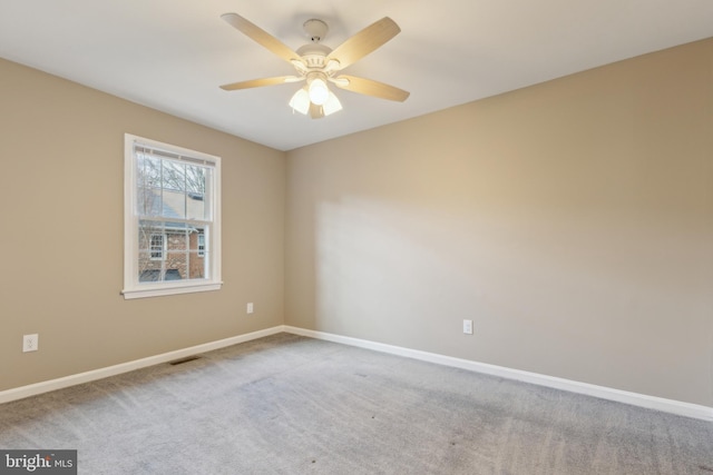 carpeted empty room featuring ceiling fan