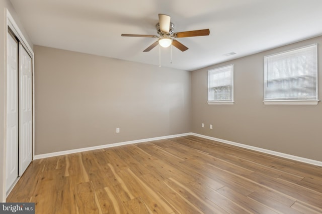 unfurnished bedroom with ceiling fan and light hardwood / wood-style flooring