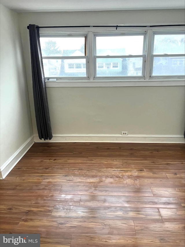 empty room featuring dark wood-type flooring