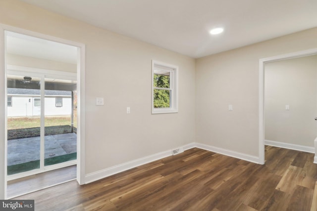 spare room featuring dark hardwood / wood-style floors