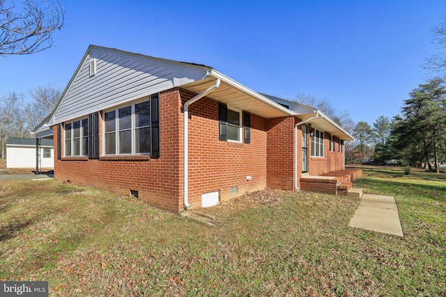 view of side of property with a lawn