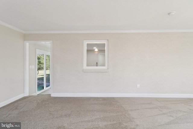 carpeted spare room featuring ornamental molding