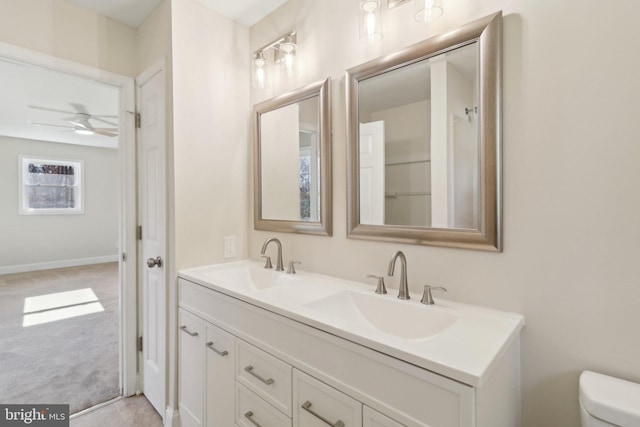 bathroom featuring ceiling fan, toilet, and vanity