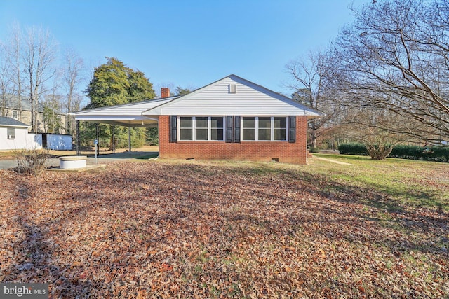 view of side of home featuring a carport