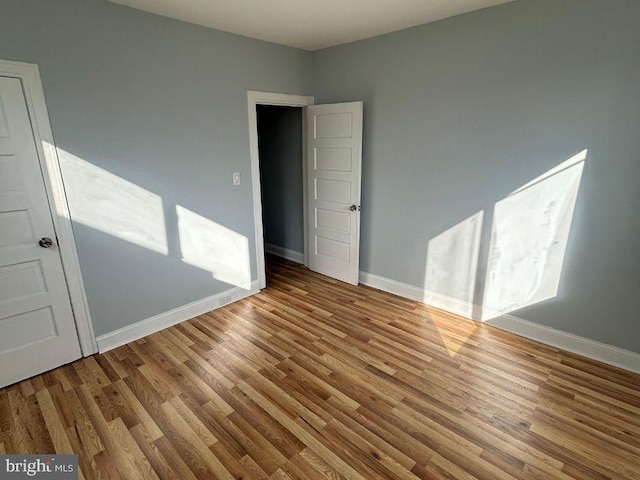 empty room with light hardwood / wood-style floors