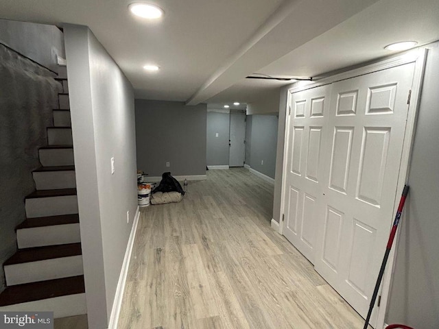 basement with light hardwood / wood-style floors