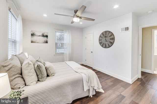 bedroom with ceiling fan and dark hardwood / wood-style floors