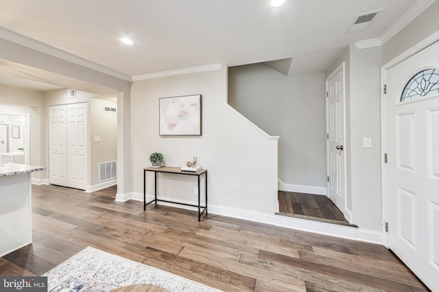 entrance foyer with light wood-type flooring and ornamental molding