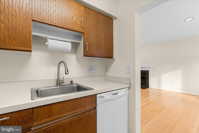 kitchen with hardwood / wood-style flooring, dishwasher, and sink