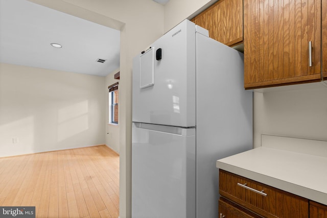 kitchen with white fridge and light wood-type flooring