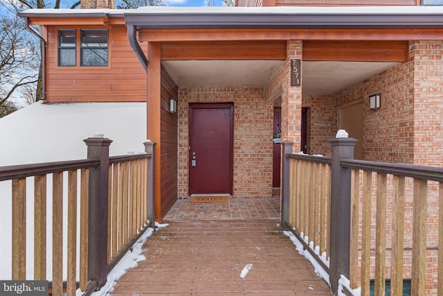 view of snow covered property entrance