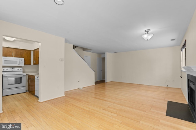 unfurnished living room with light hardwood / wood-style flooring