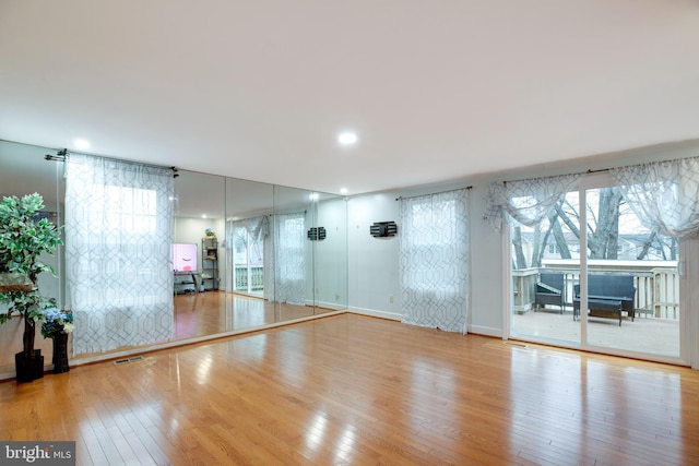 exercise area featuring light hardwood / wood-style flooring