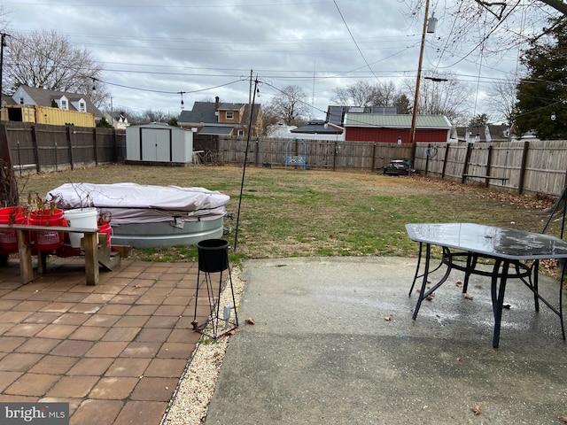 view of patio / terrace featuring a storage shed