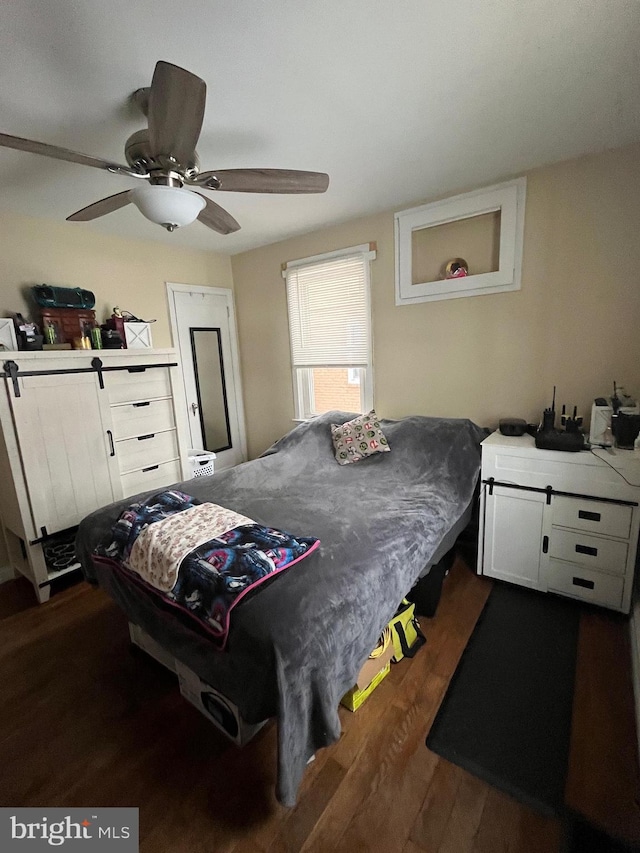 bedroom featuring ceiling fan and dark hardwood / wood-style flooring