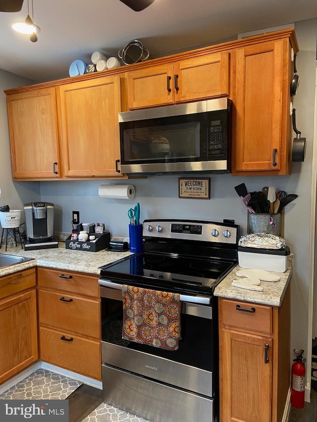 kitchen featuring light stone countertops and appliances with stainless steel finishes