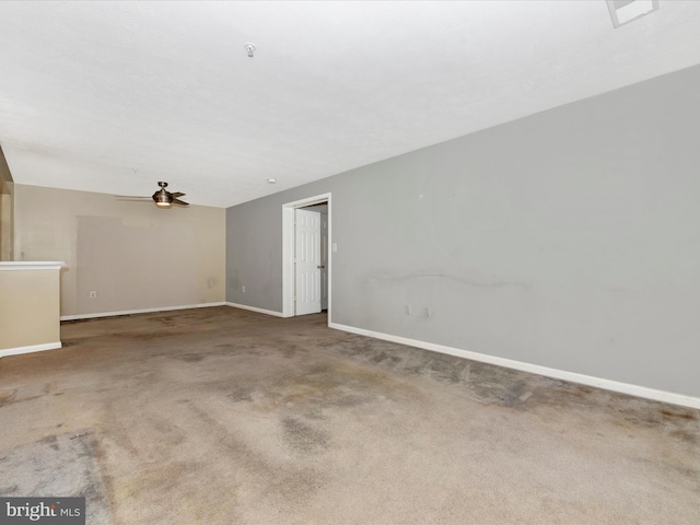 empty room with ceiling fan and carpet