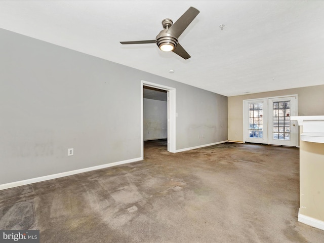 carpeted spare room with ceiling fan