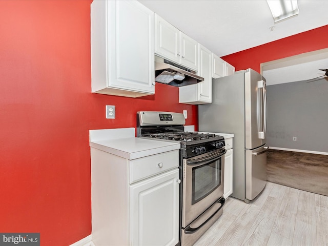 kitchen with ceiling fan, stainless steel appliances, light wood-type flooring, and white cabinets