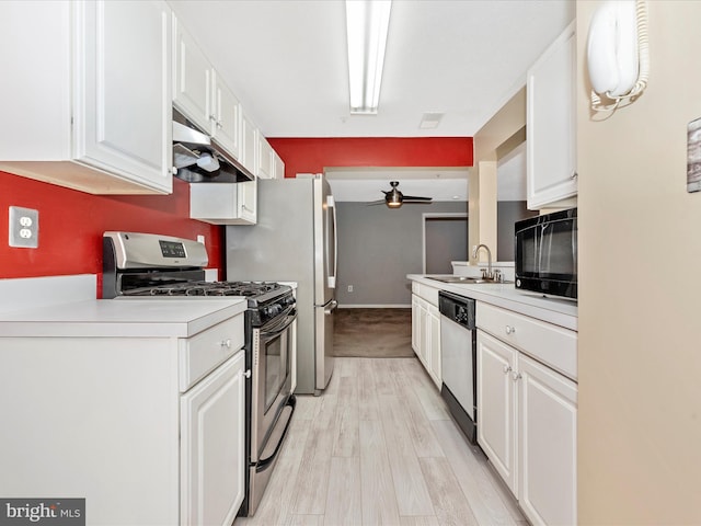 kitchen featuring white cabinetry, appliances with stainless steel finishes, sink, and light hardwood / wood-style flooring