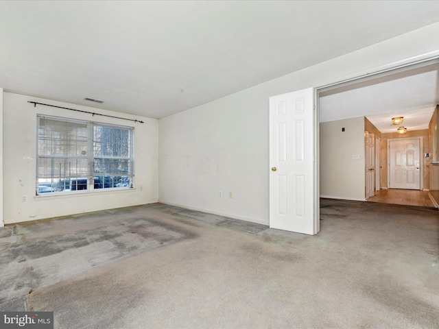 unfurnished room featuring carpet flooring