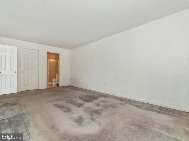 interior space featuring carpet floors and ensuite bath