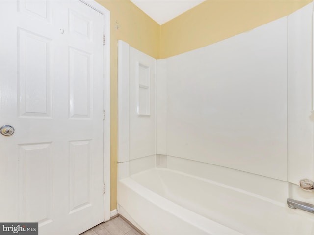 bathroom with shower / washtub combination and tile patterned flooring