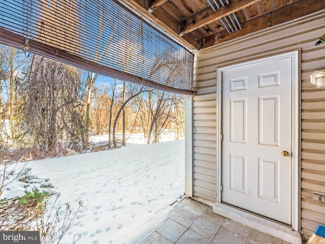 view of snow covered property entrance