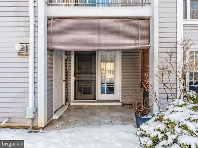 view of snow covered property entrance