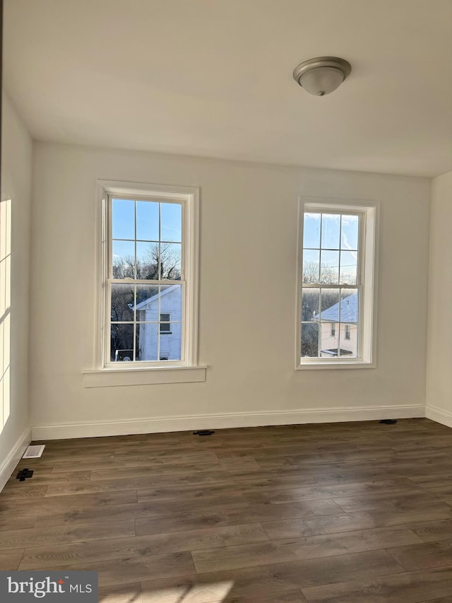 empty room featuring dark wood-type flooring