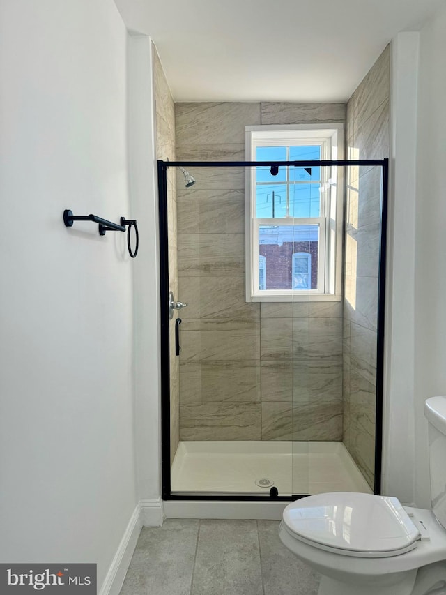 bathroom with toilet, an enclosed shower, and tile patterned flooring