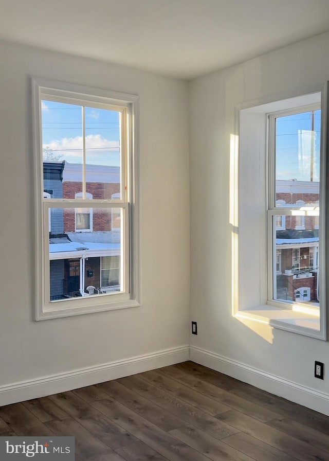 unfurnished room with dark hardwood / wood-style flooring