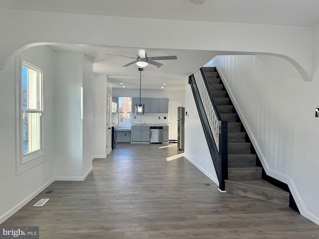 interior space with ceiling fan, sink, and wood-type flooring